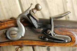 which part of a modern firearm has the same function as the lock on a muzzleloader?